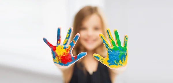 Girl showing painted hands — Stock Photo, Image