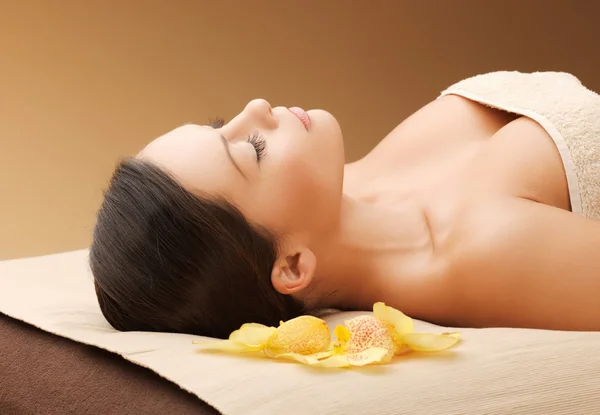 Woman in spa salon lying on the massage desk Stock Picture