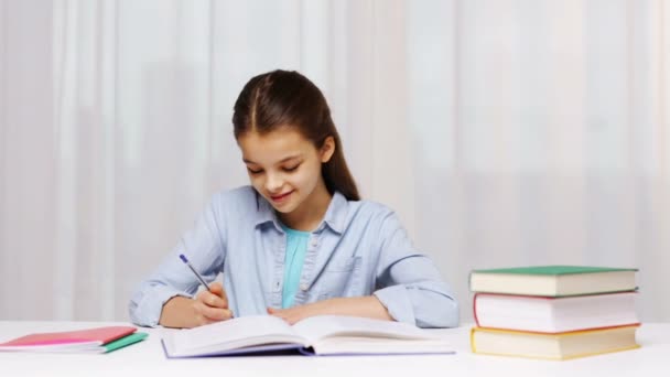 School girl writing math task to notepad — Stock Video