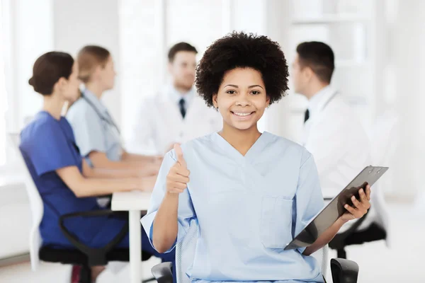 Happy doctor over group of medics at hospital — Stock Photo, Image