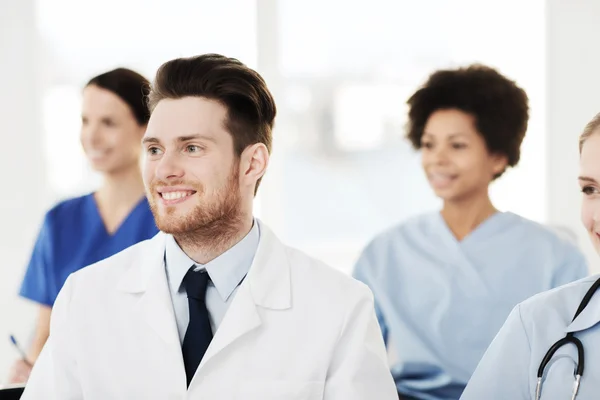 Happy doctor over group of medics at hospital — Stock Photo, Image