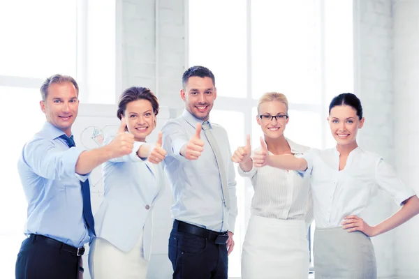 Business team showing thumbs up in office Stock Picture