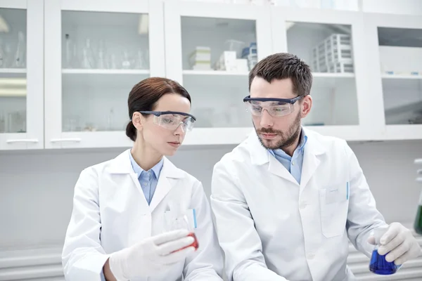 Young scientists making test or research in lab — Stock Photo, Image