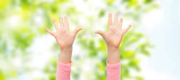 Close up of little child hands raised upwards — Stock Photo, Image