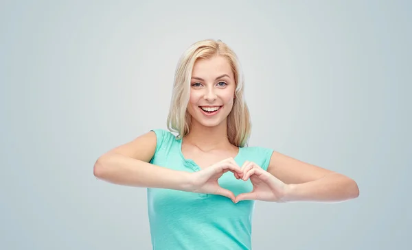 Happy woman or teen girl showing heart shape sigh — Foto Stock