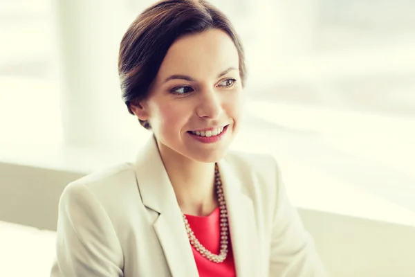 Happy elegant young woman in jacket at office — Stock Photo, Image