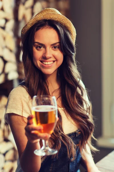 Happy young woman drinking water at bar or pub — Stock Photo, Image