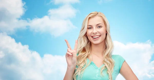 Smiling young woman or teenage girl showing peace — Stock Photo, Image