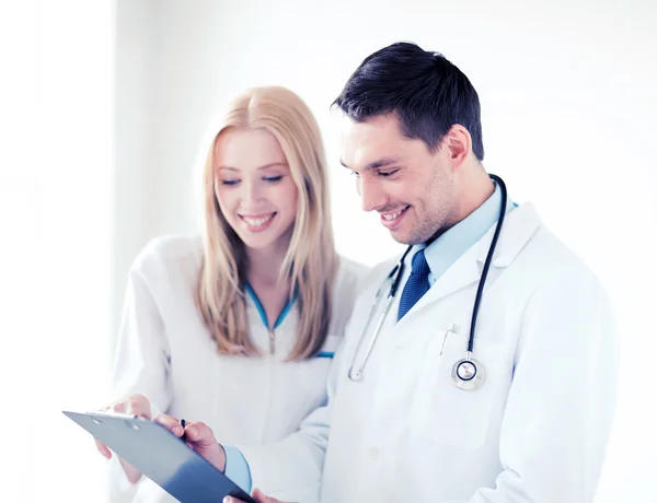 Two doctors writing prescription Stock Image