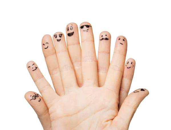 Κοντινό πλάνο της χέρια και τα δάχτυλα με χαμογελαστά πρόσωπα — Φωτογραφία Αρχείου