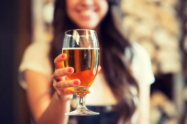 Happy woman holding glass of draft lager beer — Stock Photo, Image