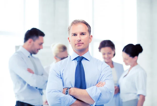 Handsome businessman with team in office — Stock Photo, Image