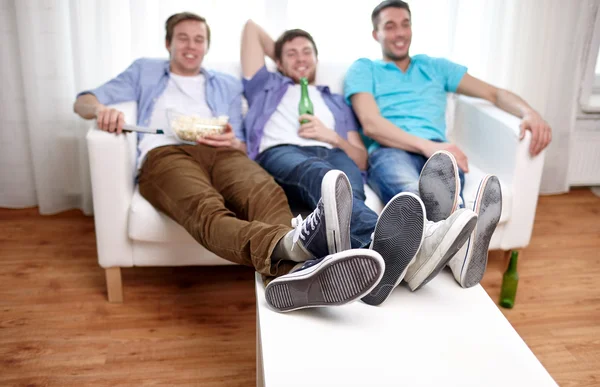 Close up of male friends watching tv at home — Stock Photo, Image