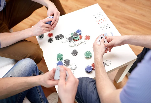 Close up of male friends playing cards at home — Stock Photo, Image