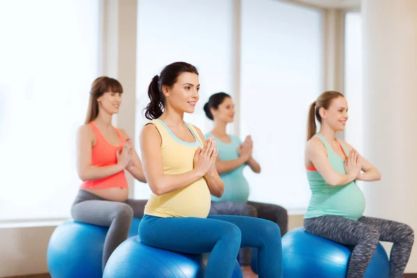 Happy pregnant women exercising on fitball in gym — Stock Photo, Image