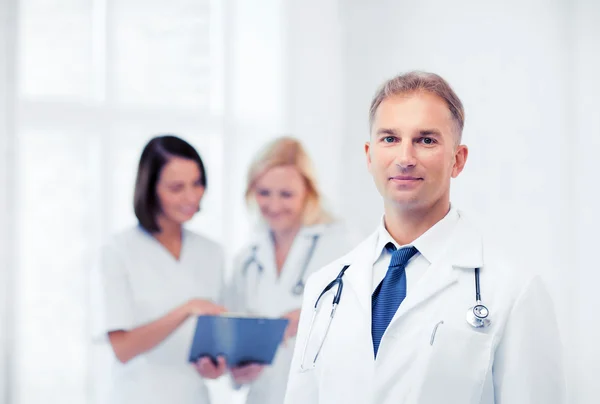 Male doctor with colleagues Royalty Free Stock Photos