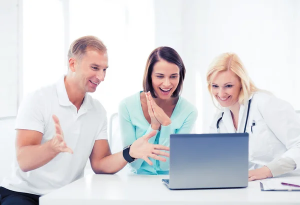 Médico com pacientes olhando para laptop Imagem De Stock