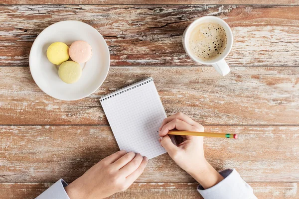 Primo piano di mani, notebook, caffè e biscotti — Foto Stock
