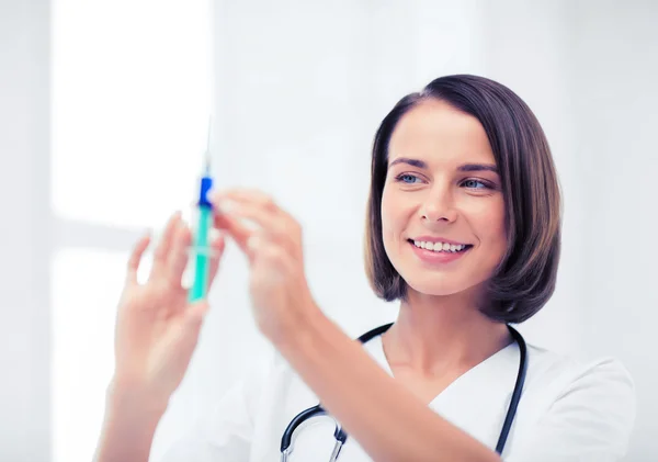 Female doctor holding syringe with injection — Stock Photo, Image