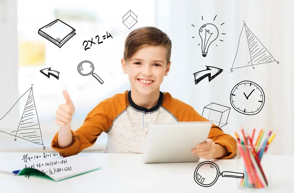 Happy boy with tablet pc showing thumbs up at home — Stock Photo, Image