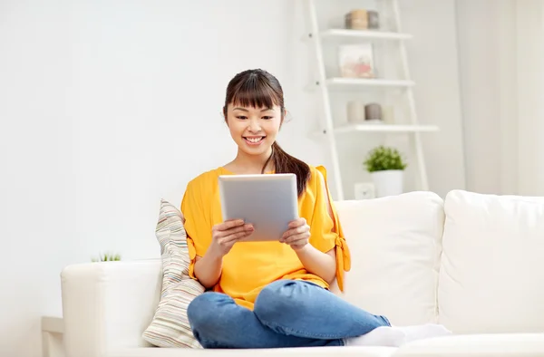 Happy young asian woman with tablet pc at home — Stock Photo, Image