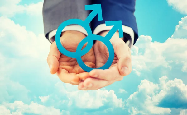 Close up of male gay couple holding gender symbol — Stock Photo, Image