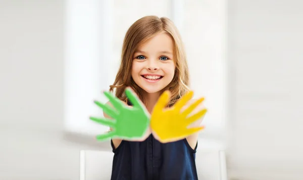 Girl showing painted hands — Stock Photo, Image