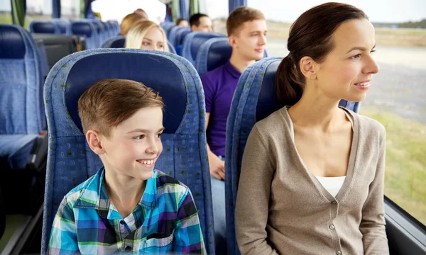 Happy family riding in travel bus — Stock Photo, Image