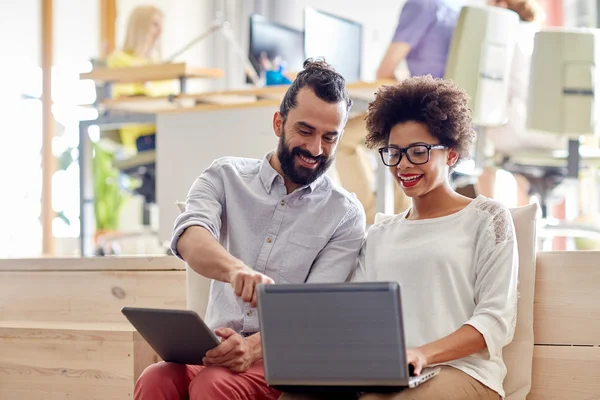 Creative team with laptop and tablet pc in office — Stock Photo, Image