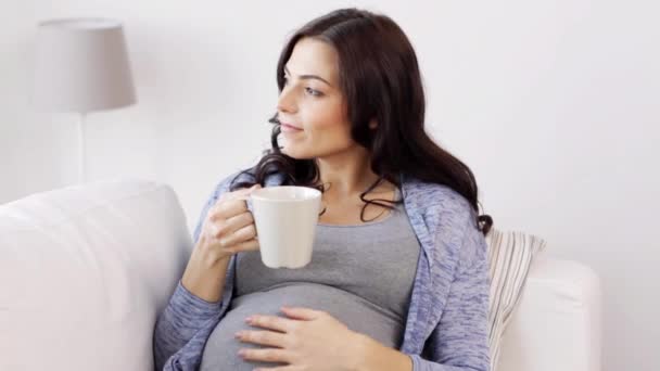 Happy pregnant woman with cup drinking tea at home — Stock Video