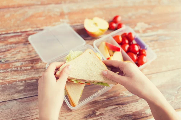 Close up of woman with food in plastic container — Stock Photo, Image