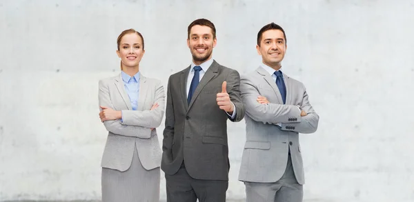 Happy business team showing thumbs up — Stock Photo, Image