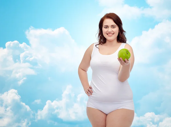 Gelukkig plus size vrouw in ondergoed met apple — Stockfoto