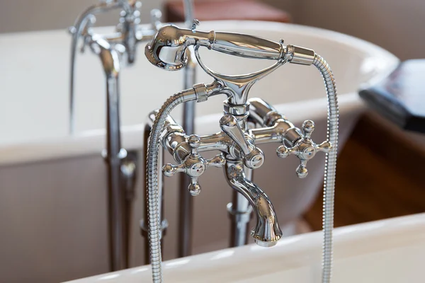 Close up of bath tap and shower at bathroom — Stock Photo, Image