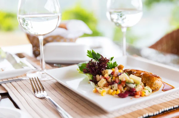 Close up of food and water glasses at restaurant — Stock Photo, Image