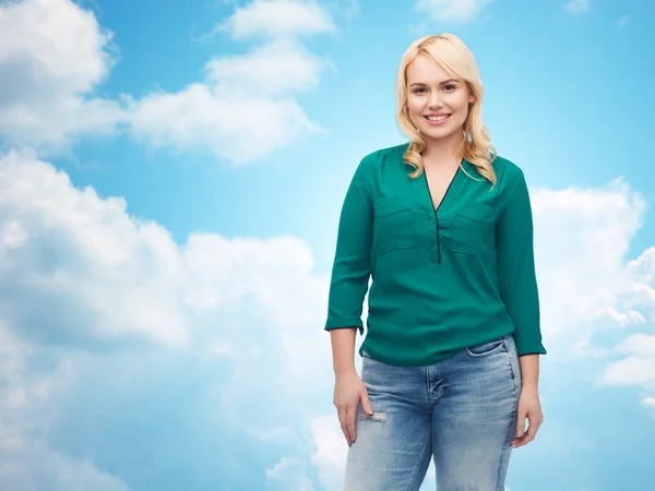 Smiling young woman in shirt and jeans — Stock Photo, Image