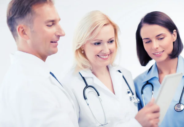 Doctors looking at tablet pc Stock Photo