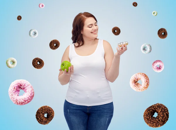 Gelukkig plus size vrouw kiezen van apple of cookie — Stockfoto