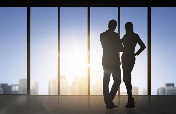 Silhouettes of business partners over office — Stock Photo, Image