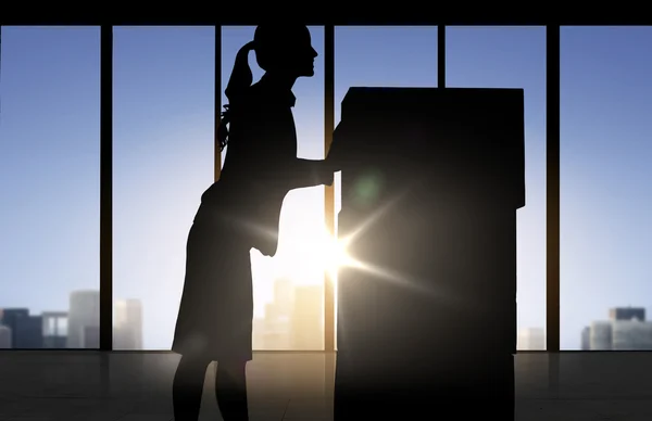 Silhouette of businesswoman moving boxes at office — Stock Photo, Image