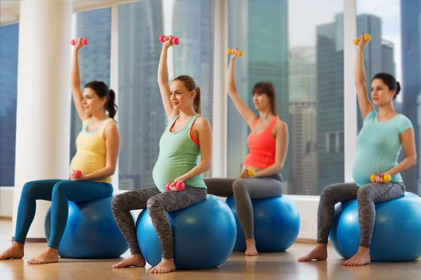 Mujeres embarazadas felices haciendo ejercicio en fitball en el gimnasio — Foto de Stock