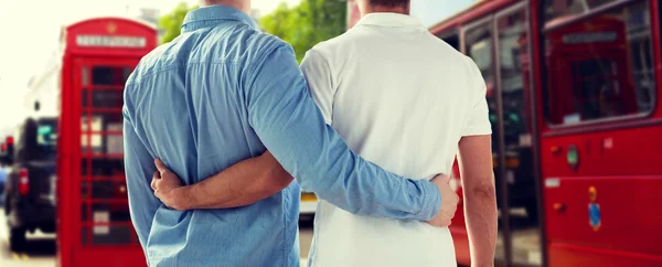 Close up of gay couple hugging over london city — 图库照片