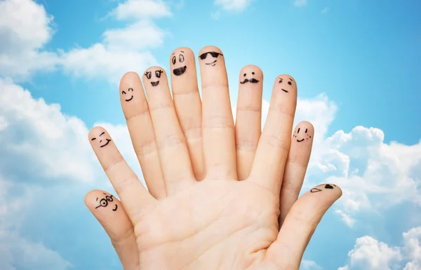 Close up of hands and fingers with smiley faces — Stock Photo, Image