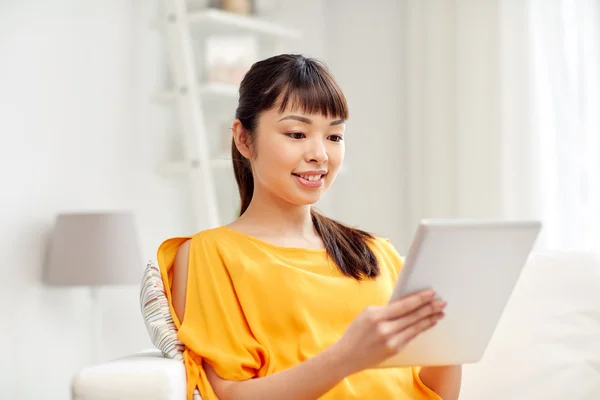 Happy young asian woman with tablet pc at home — Stock Photo, Image