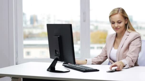 Bilgisayar ve smartphone ile gülümseyen iş kadını — Stok video