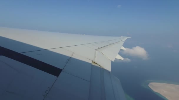 Wing of airplane flying above ocean — Stock Video