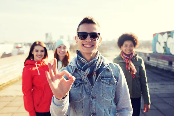 Happy teenage friends showing ok sign on street — Stock Photo, Image