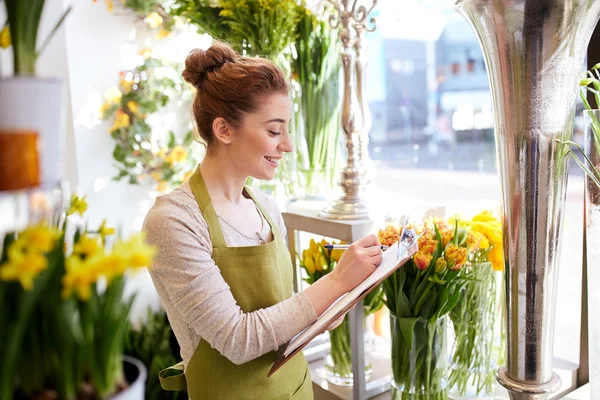 Florista mujer con portapapeles en floristería — Foto de Stock
