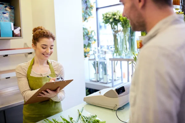 Florist woman and man making order at flower shop — Stock Photo, Image