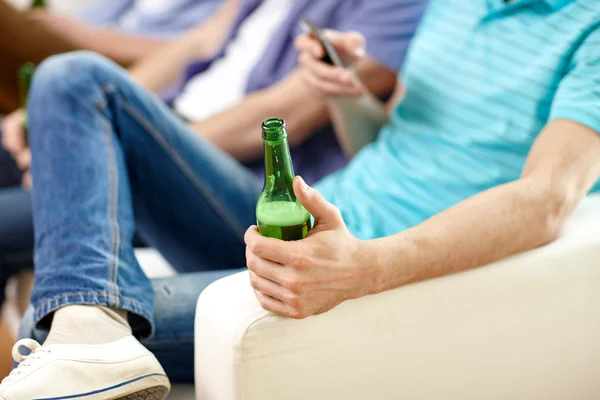 Close up of male friends drinking beer at home — Stock Photo, Image